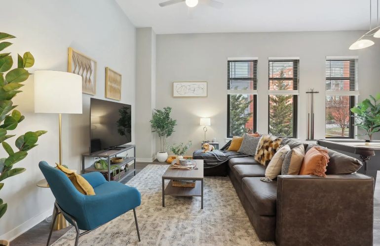 Living room with couch, coffee table, lamp, and TV